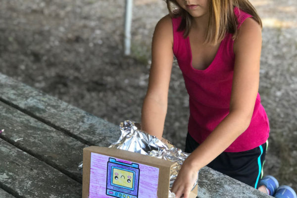 Girl making a STEM box structure