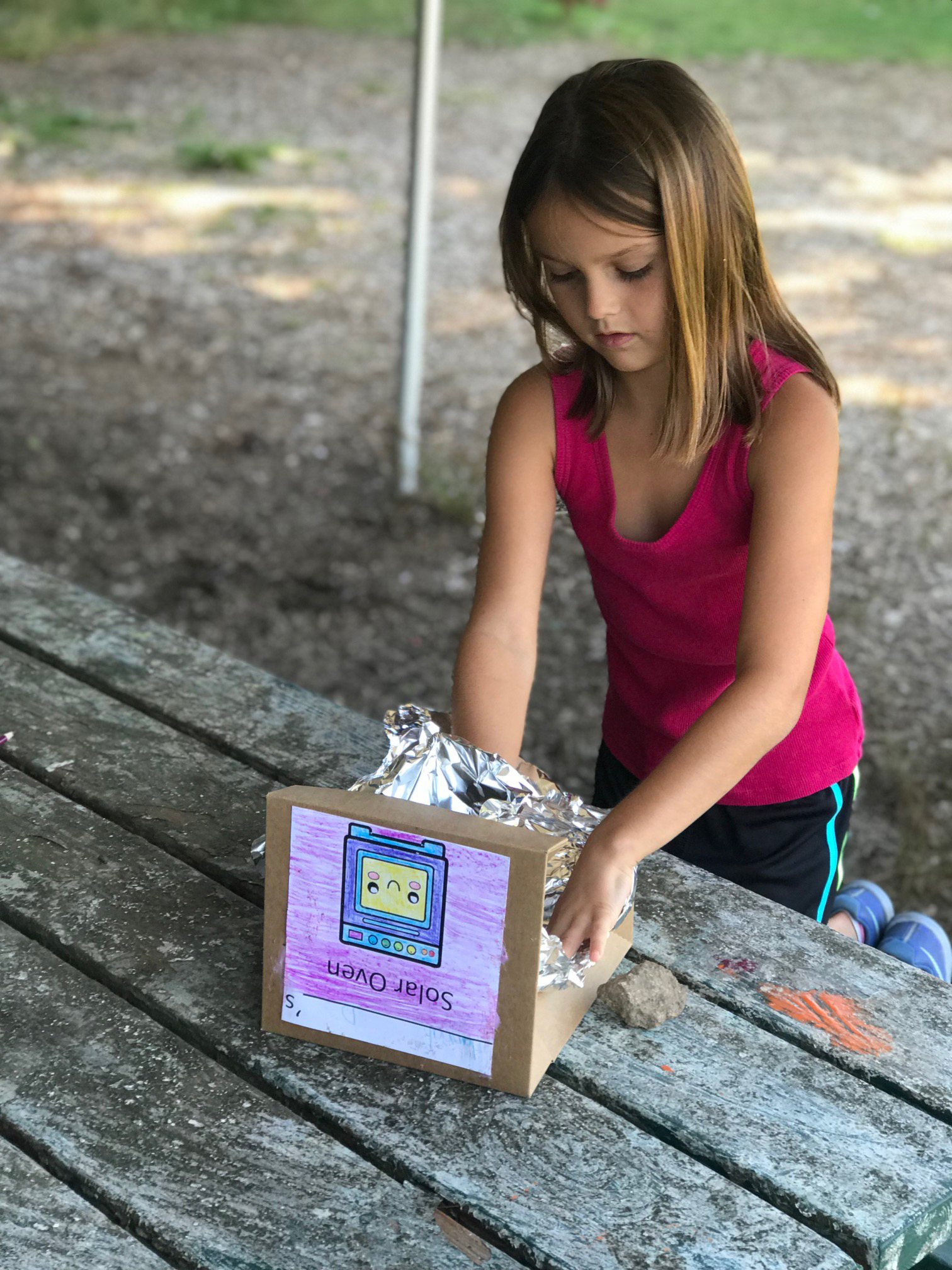 Girl making a STEM box structure